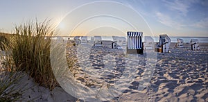 Canopied beach chairs at beach near Prerow  in evening light